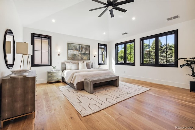 bedroom featuring light hardwood / wood-style flooring, high vaulted ceiling, and ceiling fan