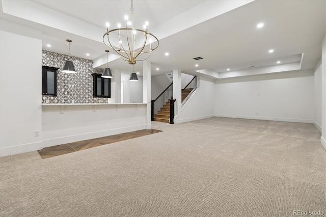 unfurnished living room with dark carpet and a raised ceiling