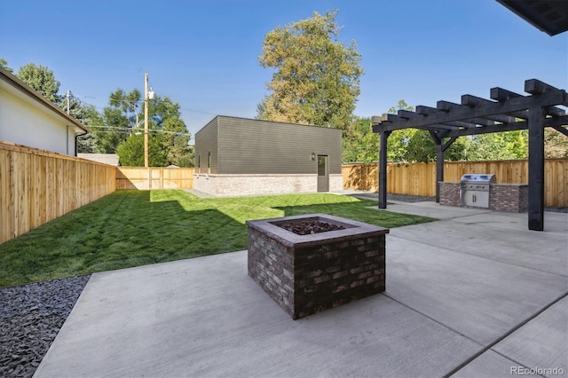 view of patio / terrace with a grill, exterior kitchen, and a fire pit