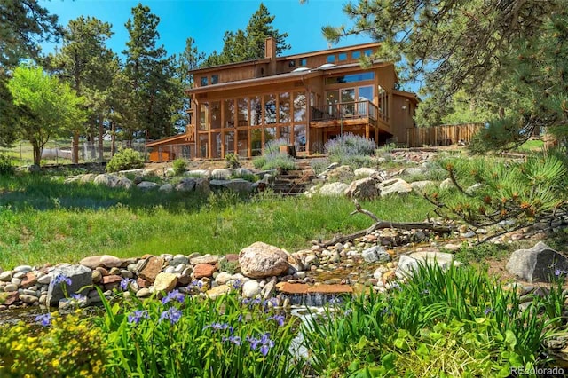 back of property featuring a wooden deck