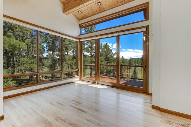 interior space featuring wooden ceiling and lofted ceiling with beams