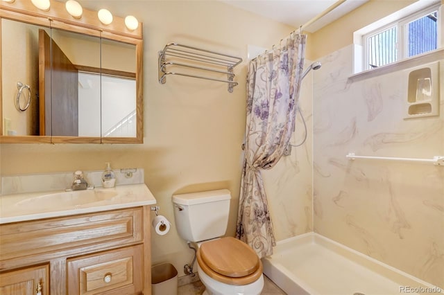 bathroom with toilet, vanity, and a shower with shower curtain