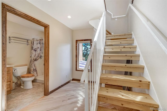 staircase featuring light hardwood / wood-style floors