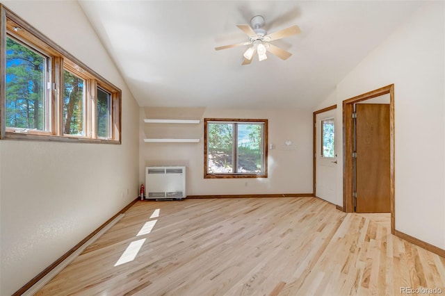 unfurnished room with light hardwood / wood-style flooring, radiator, lofted ceiling, and ceiling fan