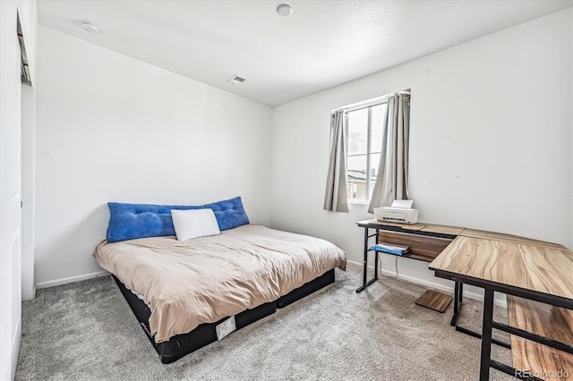 carpeted bedroom with visible vents and baseboards