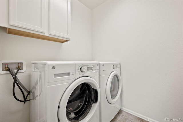 washroom with separate washer and dryer, cabinets, and light tile patterned flooring