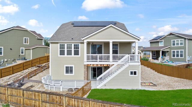 back of house with solar panels