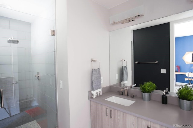 bathroom with walk in shower and vanity