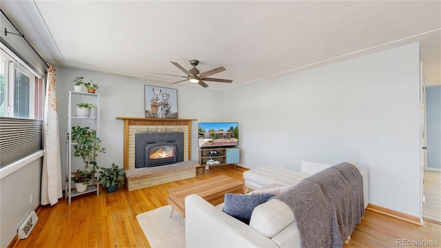 8774 Princeton St, Westminster, CO 80031 - living area featuring ceiling fan, a brick fireplace, wood finished floors, and baseboards