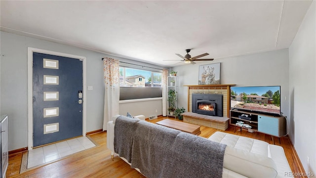 8774 Princeton St, Westminster, CO 80031 - living area with wood finished floors, a fireplace, ceiling fan, and baseboards