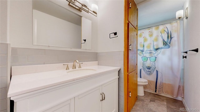 8774 Princeton St, Westminster, CO 80031 - full bathroom with vanity, toilet, tile walls, and a shower with shower curtain