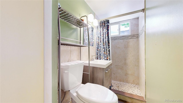 8774 Princeton St, Westminster, CO 80031 - full bath with a tile shower, vanity, and toilet