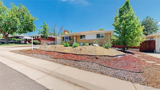 8774 Princeton St, Westminster, CO 80031 - single story home featuring brick siding, concrete driveway, a garage, and a chimney