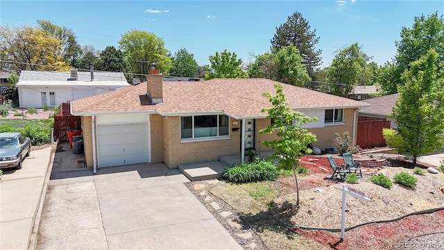 8774 Princeton St, Westminster, CO 80031 - ranch-style home featuring brick siding, concrete driveway, a garage, a chimney, and roof with shingles