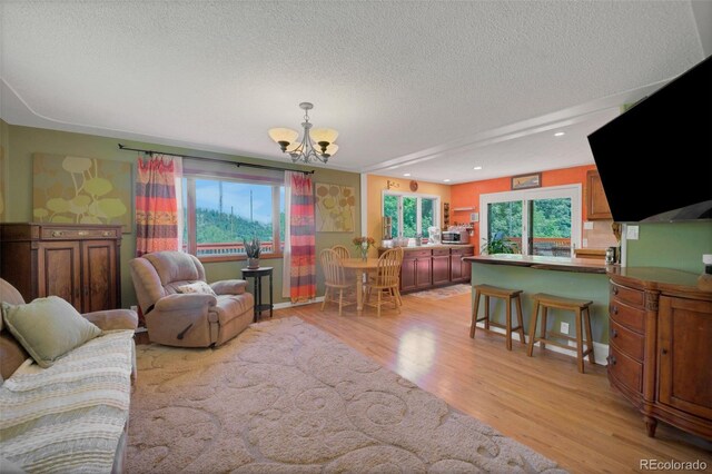 570 Columbine Ave, Golden, CO 80401 - living area featuring a chandelier, a textured ceiling, light wood finished floors, and recessed lighting