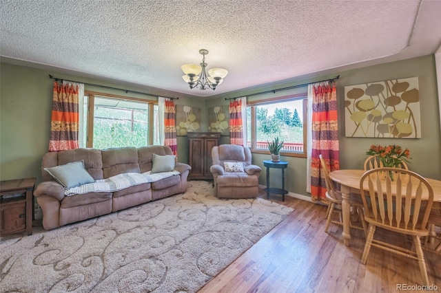 570 Columbine Ave, Golden, CO 80401 - living room featuring a chandelier, wood finished floors, and a textured ceiling