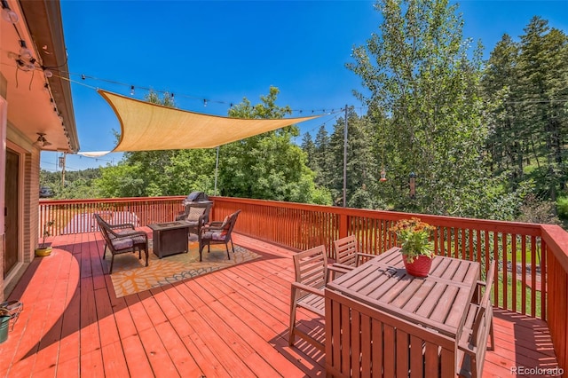 570 Columbine Ave, Golden, CO 80401 - wooden deck featuring outdoor dining space and an outdoor fire pit