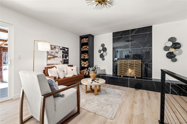 living room featuring a premium fireplace and hardwood / wood-style flooring