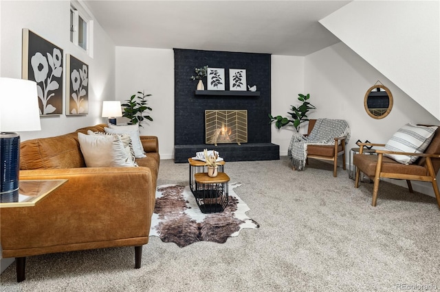 living room featuring a brick fireplace and carpet flooring