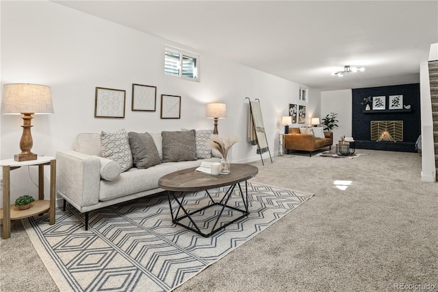 carpeted living room featuring a fireplace