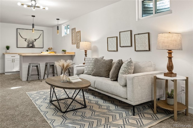 living room with light carpet and a chandelier