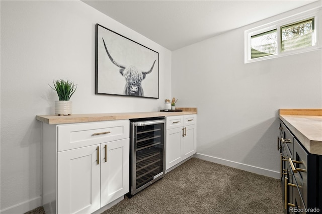 bar featuring wine cooler, butcher block countertops, and white cabinetry