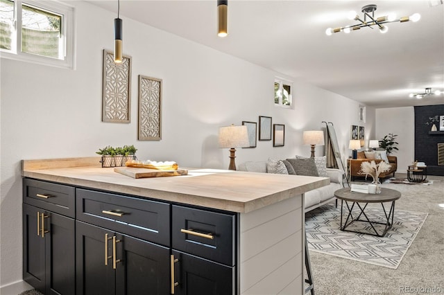 kitchen featuring a fireplace, a breakfast bar, and a notable chandelier