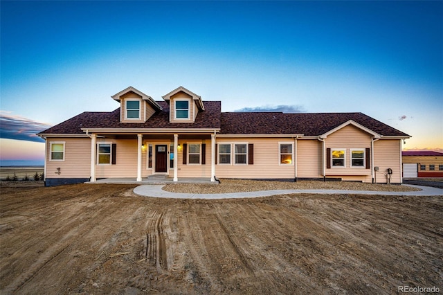 view of front of home with a shingled roof