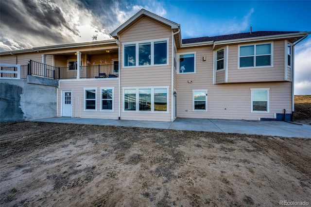 back of house featuring a patio area and a balcony