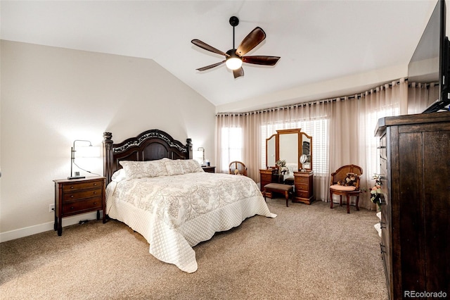 bedroom featuring a ceiling fan, light carpet, vaulted ceiling, and baseboards