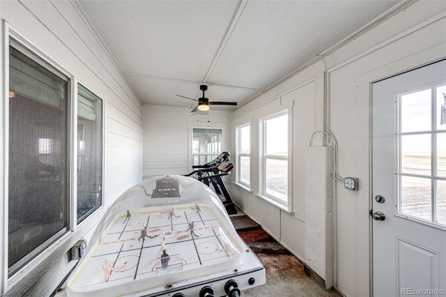 sunroom featuring a ceiling fan