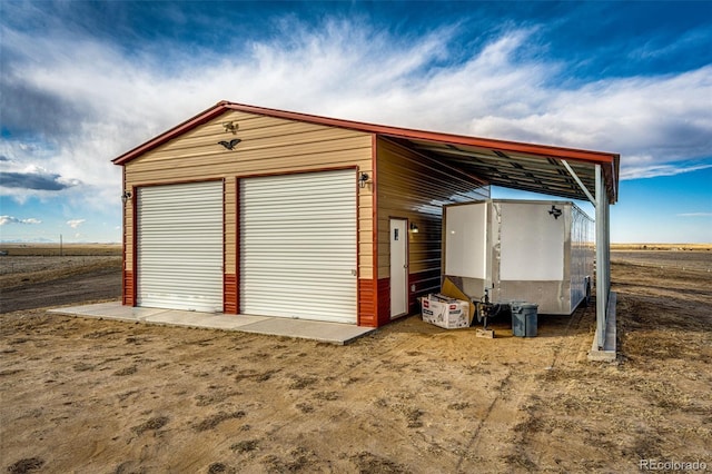 detached garage featuring a carport