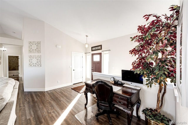 office featuring a barn door, baseboards, vaulted ceiling, and wood finished floors