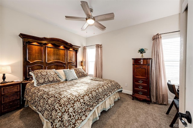 carpeted bedroom with ceiling fan and baseboards