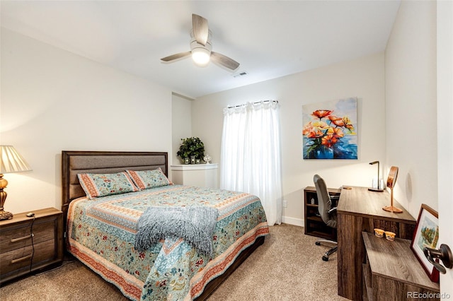 carpeted bedroom featuring baseboards, visible vents, and a ceiling fan