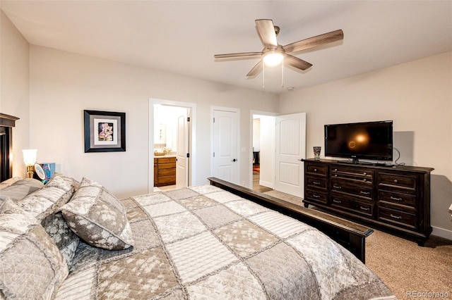 carpeted bedroom with ceiling fan, baseboards, and connected bathroom