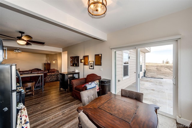 dining space with wood finished floors, beam ceiling, and a ceiling fan