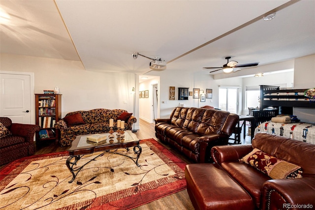 living room with ceiling fan and wood finished floors