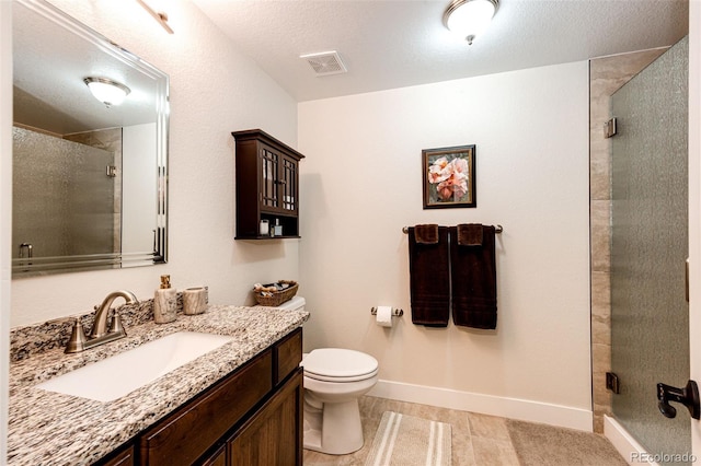 bathroom with a stall shower, baseboards, visible vents, toilet, and vanity