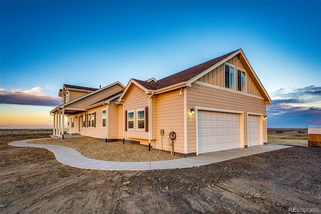 4820 S County Road 137, Bennett, CO 80102 - view of side of property featuring a garage, board and batten siding, and dirt driveway