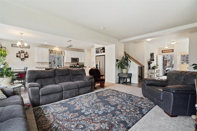 living room with a notable chandelier and carpet flooring