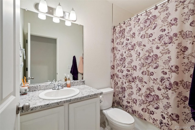 bathroom with toilet and vanity