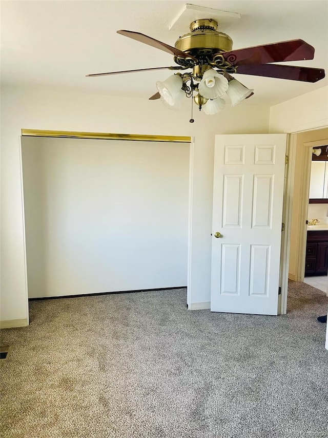 unfurnished bedroom with ceiling fan, a closet, and carpet