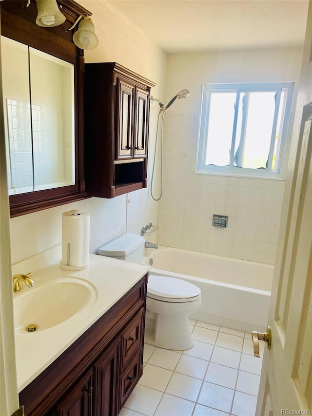 full bathroom featuring vanity, tiled shower / bath combo, toilet, and tile patterned flooring