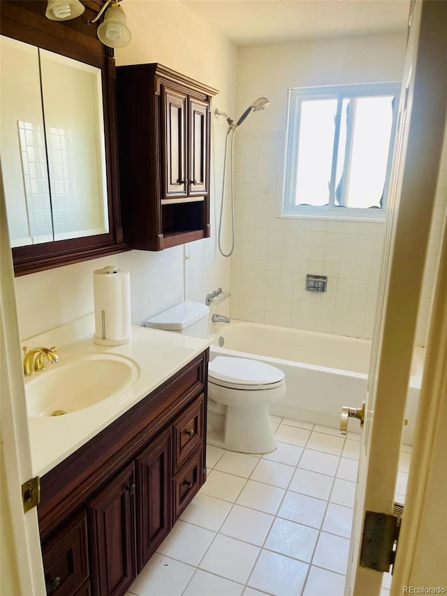 full bathroom featuring tile patterned floors, tiled shower / bath combo, toilet, and vanity