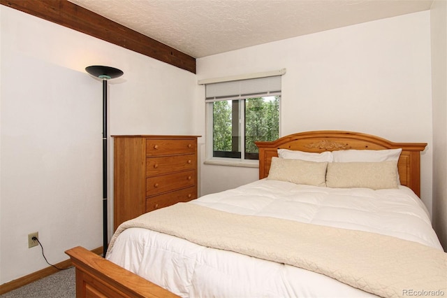 101 Ryan Gulch Ct Unit A202, Silverthorne, CO 80498 - carpeted bedroom with beam ceiling and a textured ceiling