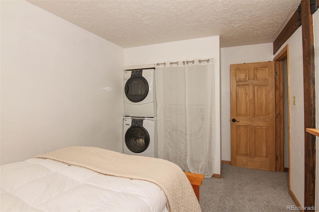101 Ryan Gulch Ct Unit A202, Silverthorne, CO 80498 - carpeted bedroom with estacked washer and dryer and a textured ceiling