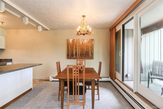 101 Ryan Gulch Ct Unit A202, Silverthorne, CO 80498 - dining area featuring a baseboard radiator, baseboard heating, a chandelier, light colored carpet, and a textured ceiling