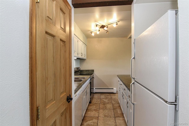 101 Ryan Gulch Ct Unit A202, Silverthorne, CO 80498 - kitchen featuring freestanding refrigerator, dark countertops, a baseboard radiator, stainless steel range with electric cooktop, and white cabinets
