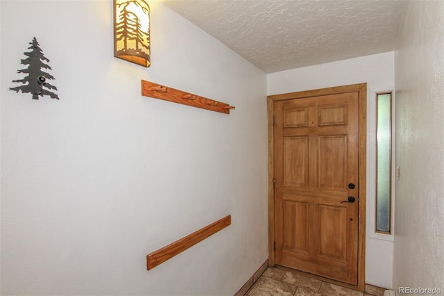 101 Ryan Gulch Ct Unit A202, Silverthorne, CO 80498 - entryway with light stone finish floors and a textured ceiling